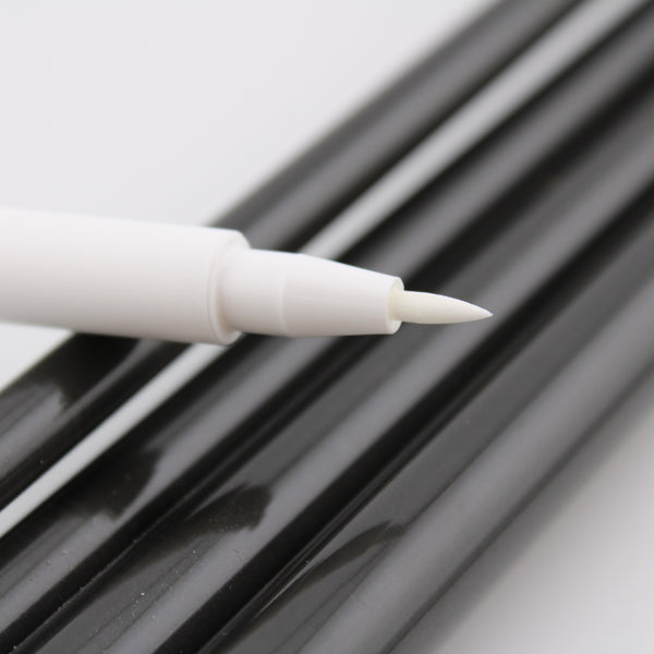 White fine brush tip india ink pen